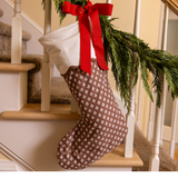 Decorative Christmas stocking with a red bow on a staircase
