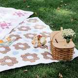 Trudie Constance Chocolate Quilted Throw Blanket styled with a picnic basket