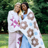 Trudie Constance Chocolate Quilted Throw Blanket wrapped around individuals
