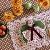 Trudie Constance Chocolate Round Tablecloth with Ruffle on a table setting with placemat and napkins