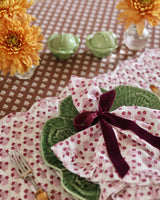 Trudie Constance Chocolate Round Tablecloth with Ruffle alternate view of a table setting with placemat and napkins